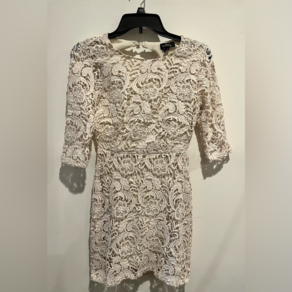 White knit open back dress with sheer sleeves. Size small.